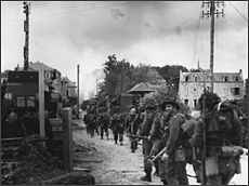 Troops of the Régiment de la Chaudière, 8th Brigade, push inland toward Bény-sur-Mer.